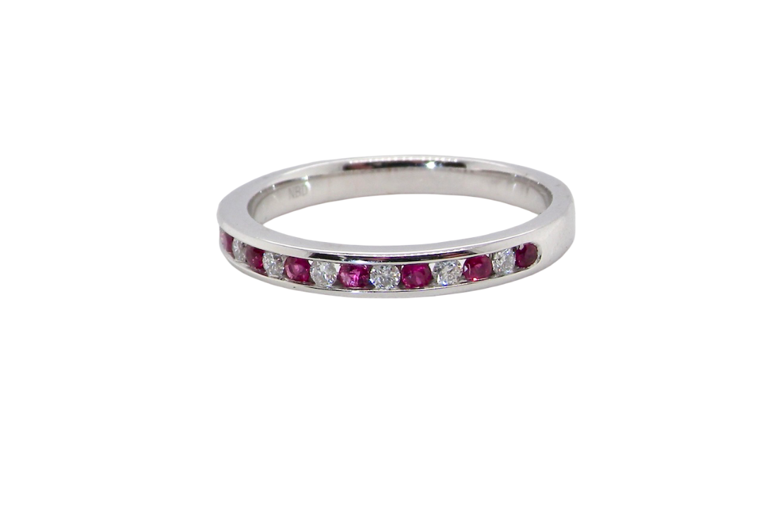 new A white gold half hoop eternity ring. Set with seven round rubies and six brilliant cut white diamonds