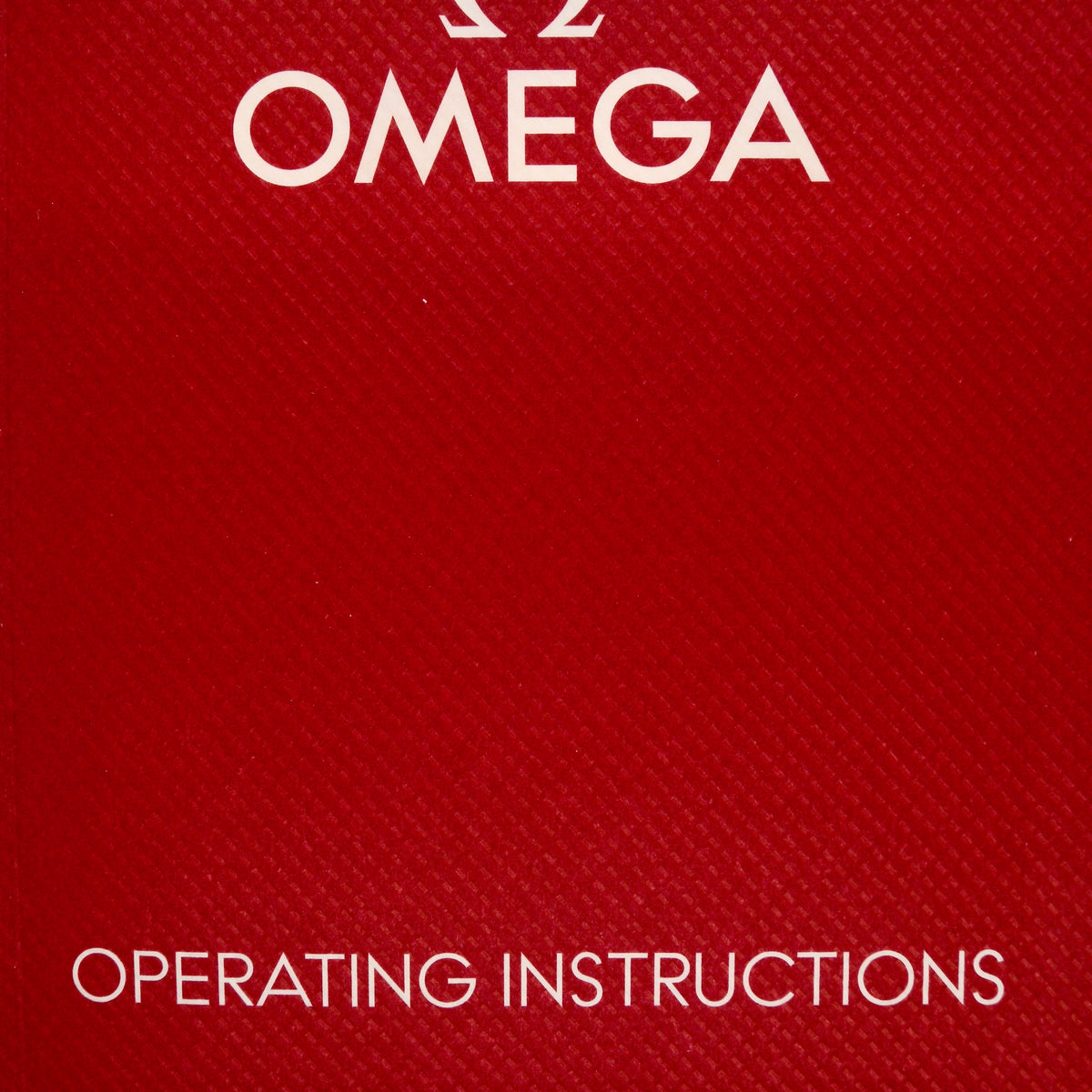 A close-up of a red textured Omega box or booklet cover with the word OMEGA at the top and OPERATING INSTRUCTIONS at the bottom in white text.