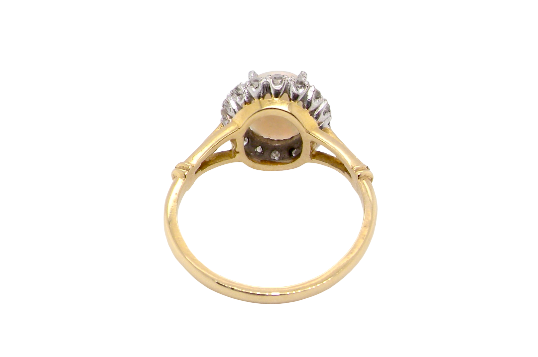 opal A vintage cluster ring. Features an oval white opal, measures 10x8mm, with a good play of colour.