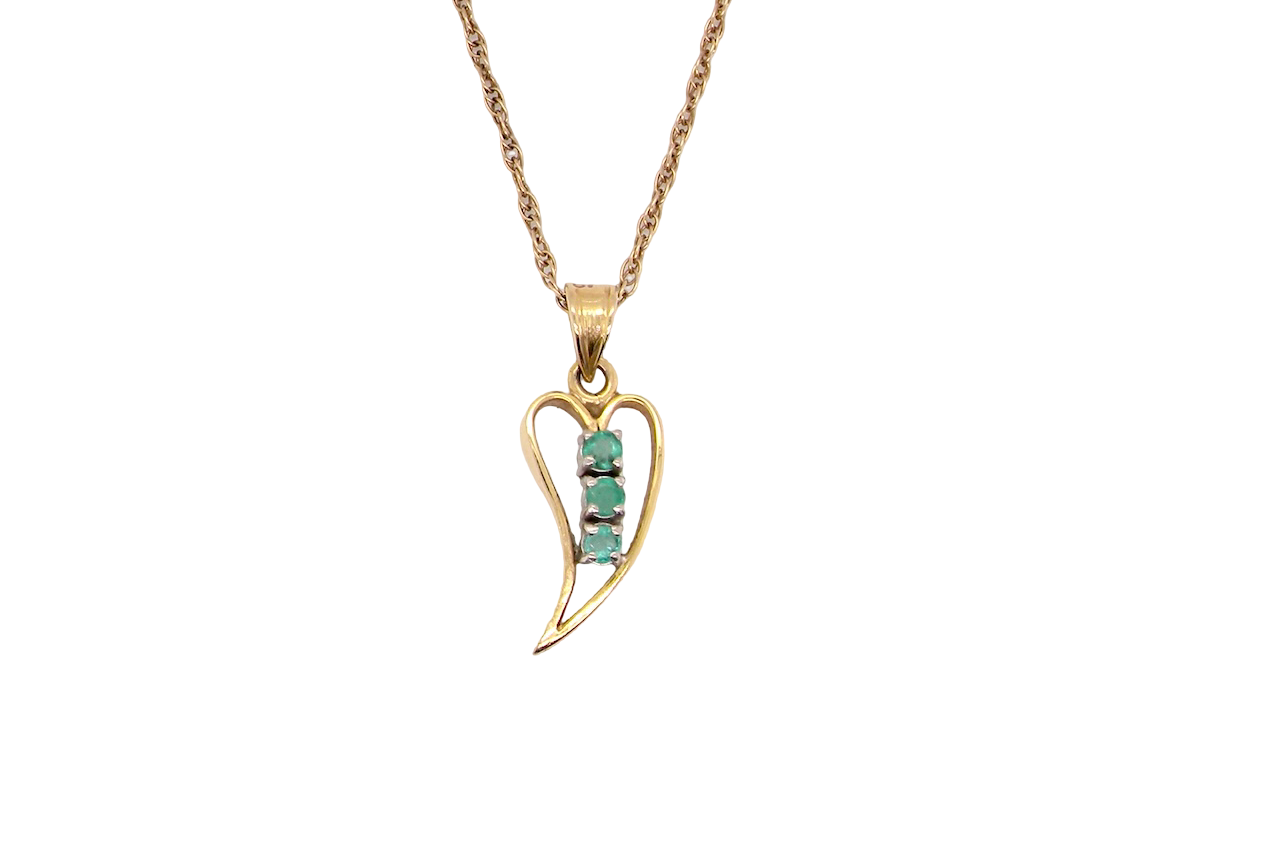 open-heart pendant, beautifully set with three emeralds,