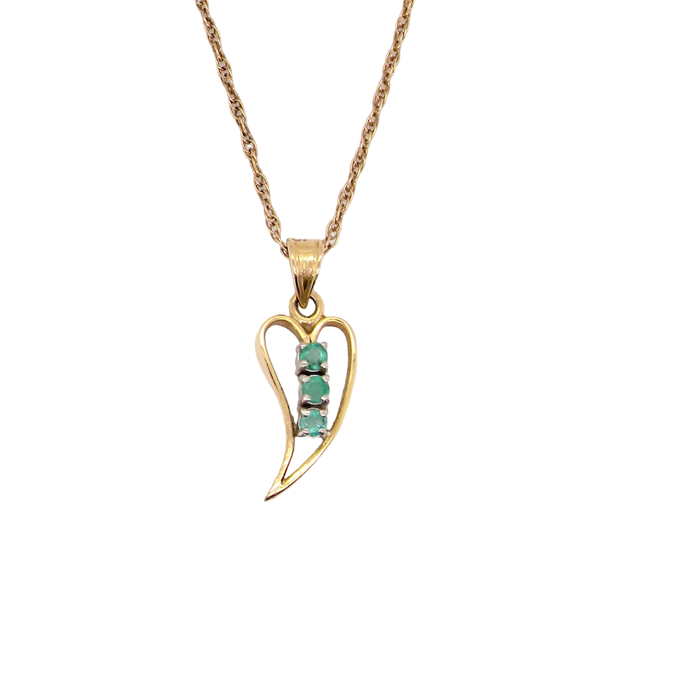open-heart pendant, beautifully set with three emeralds,