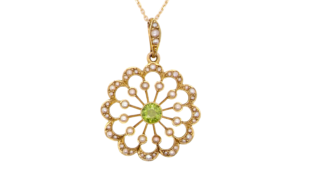 pendant from the Edwardian- Age of Elegance-
The centre stone- a round peridot 5mm diameter, mille grain set. A satellite perimeter of twelve seed pearls, each 2.4mm. The outside border is scalloped shaped