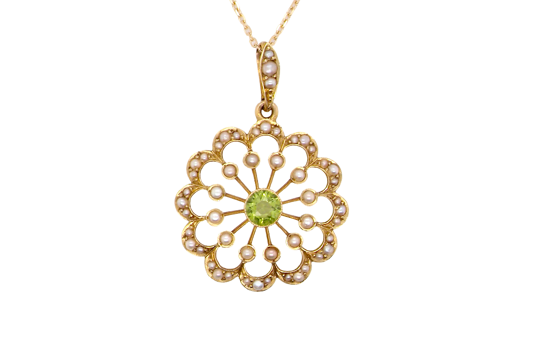 pendant from the Edwardian- Age of Elegance-
The centre stone- a round peridot 5mm diameter, mille grain set. A satellite perimeter of twelve seed pearls, each 2.4mm. The outside border is scalloped shaped