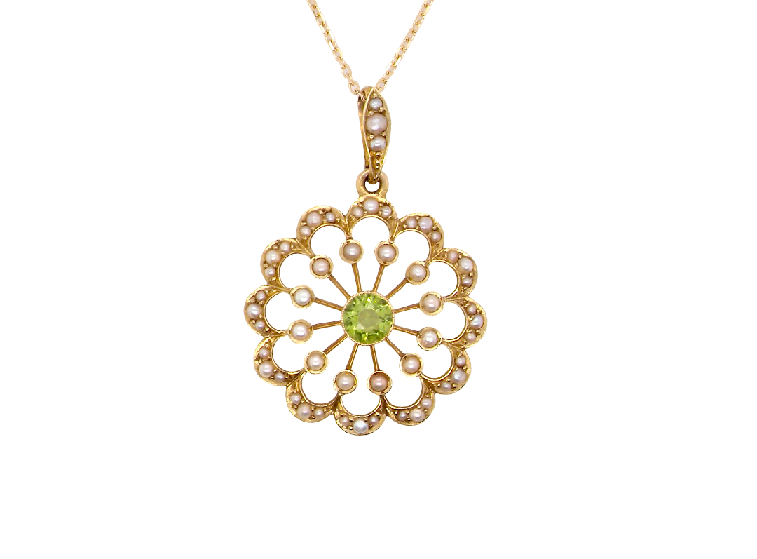 pendant from the Edwardian- Age of Elegance-
The centre stone- a round peridot 5mm diameter, mille grain set. A satellite perimeter of twelve seed pearls, each 2.4mm. The outside border is scalloped shaped