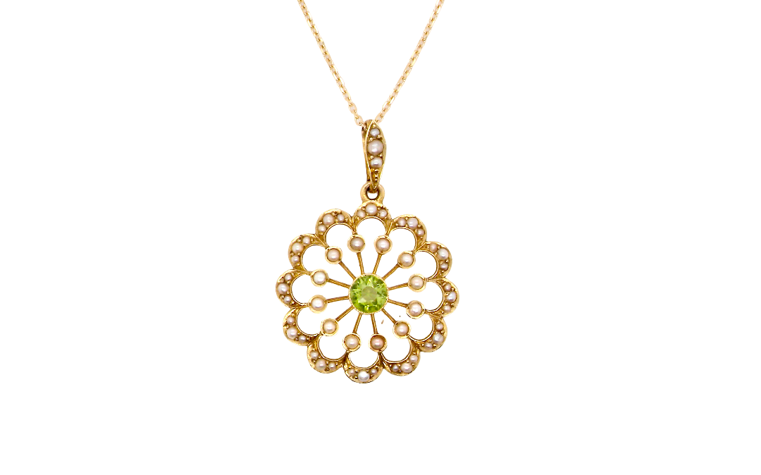 pendant from the Edwardian- Age of Elegance-
The centre stone- a round peridot 5mm diameter, mille grain set. A satellite perimeter of twelve seed pearls, each 2.4mm. The outside border is scalloped shaped and each crescent is set with tiny seed pearls.