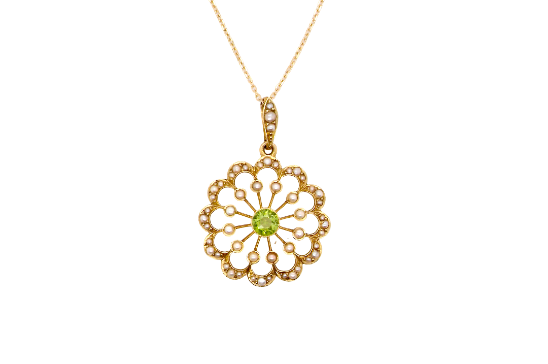 pendant from the Edwardian- Age of Elegance-
The centre stone- a round peridot 5mm diameter, mille grain set. A satellite perimeter of twelve seed pearls, each 2.4mm. The outside border is scalloped shaped and each crescent is set with tiny seed pearls.
