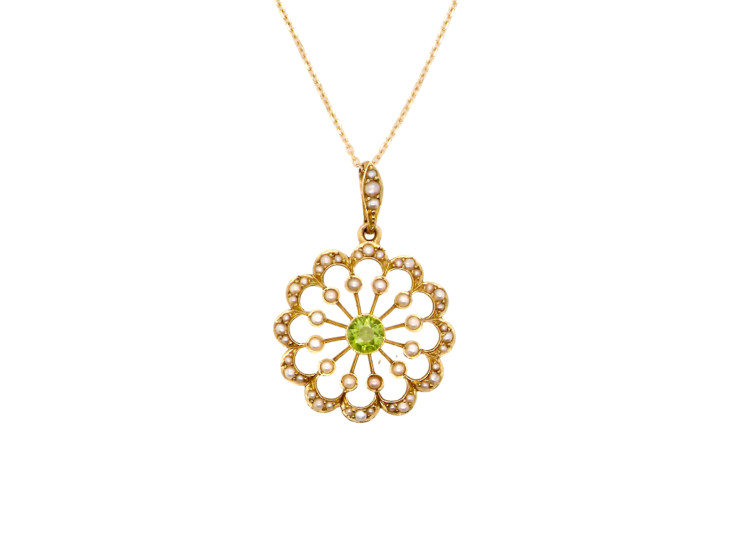pendant from the Edwardian- Age of Elegance-
The centre stone- a round peridot 5mm diameter, mille grain set. A satellite perimeter of twelve seed pearls, each 2.4mm. The outside border is scalloped shaped and each crescent is set with tiny seed pearls.
