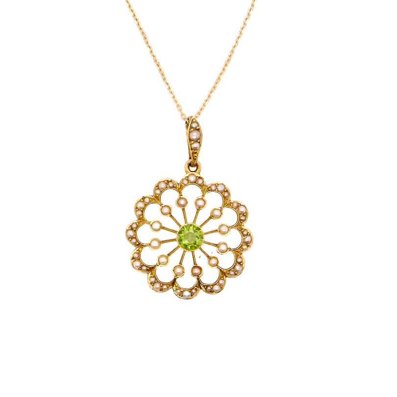 pendant from the Edwardian- Age of Elegance-
The centre stone- a round peridot 5mm diameter, mille grain set. A satellite perimeter of twelve seed pearls, each 2.4mm. The outside border is scalloped shaped and each crescent is set with tiny seed pearls.