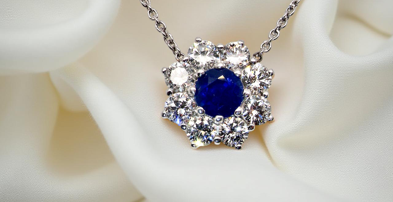 pendant with a vibrant blue sapphire at its centre.