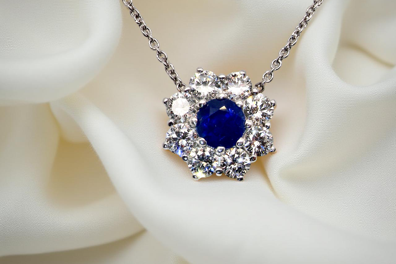 pendant with a vibrant blue sapphire at its centre.