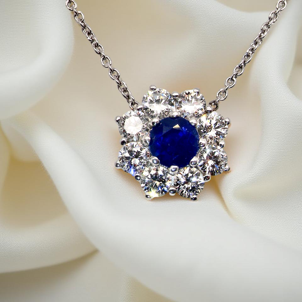 pendant with a vibrant blue sapphire at its centre.