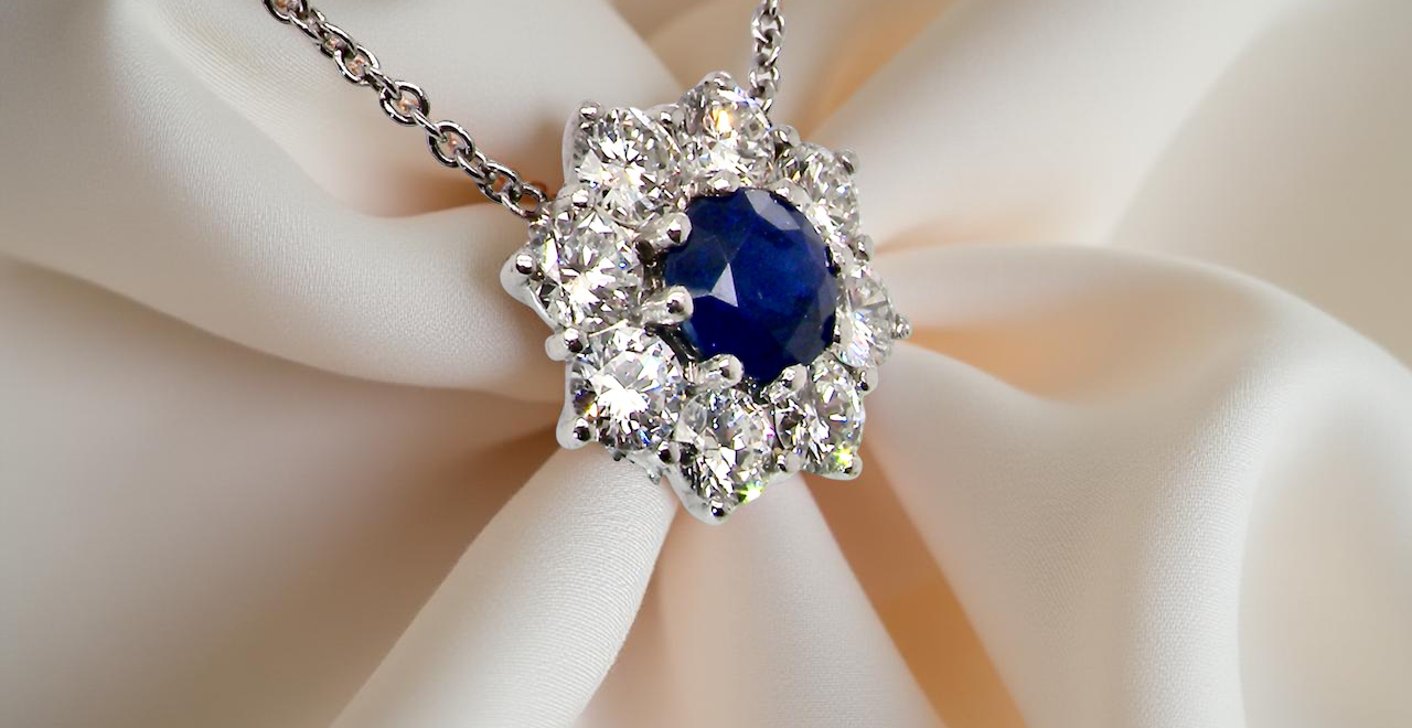 pendant with a vibrant sapphire at its centre.