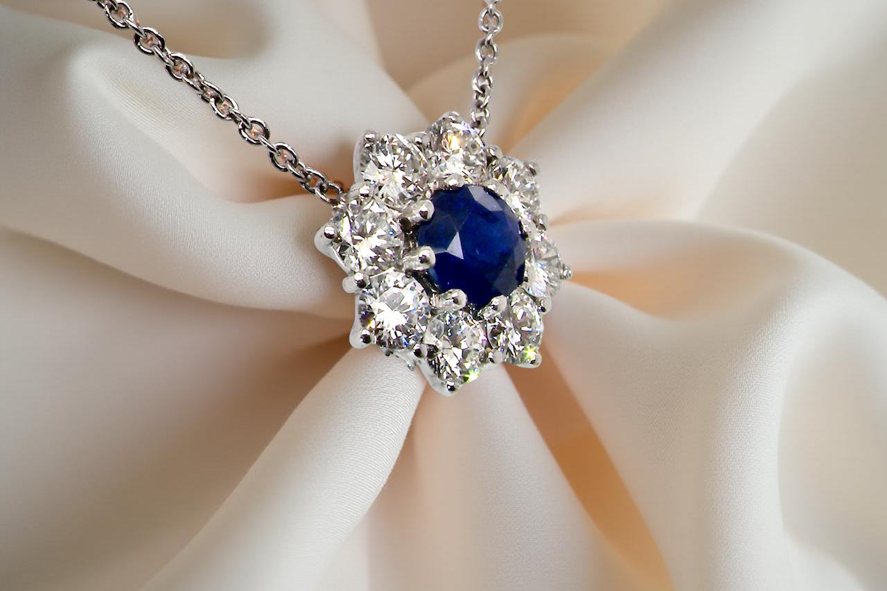 pendant with a vibrant sapphire at its centre.