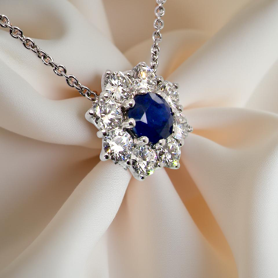 pendant with a vibrant sapphire at its centre.