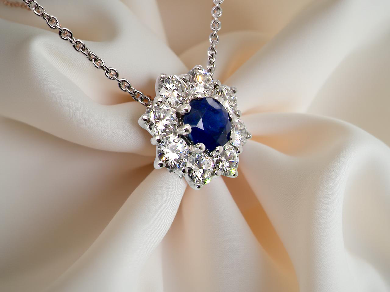 pendant with a vibrant sapphire at its centre.