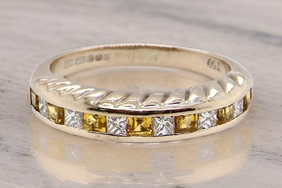 a fine yellow sapphire and diamond eternity ring