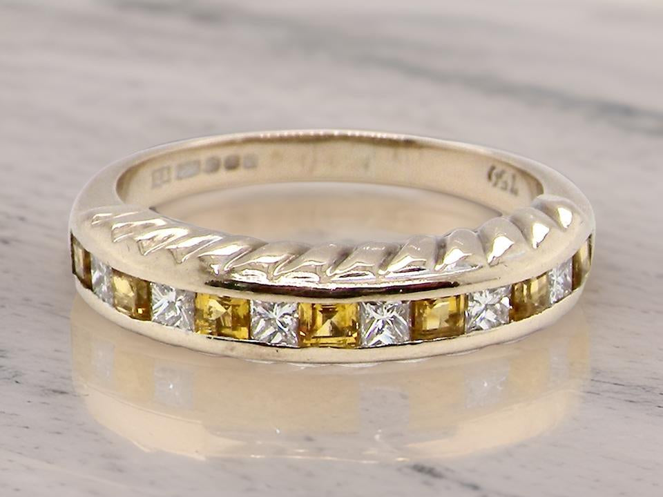 a fine yellow sapphire and diamond eternity ring