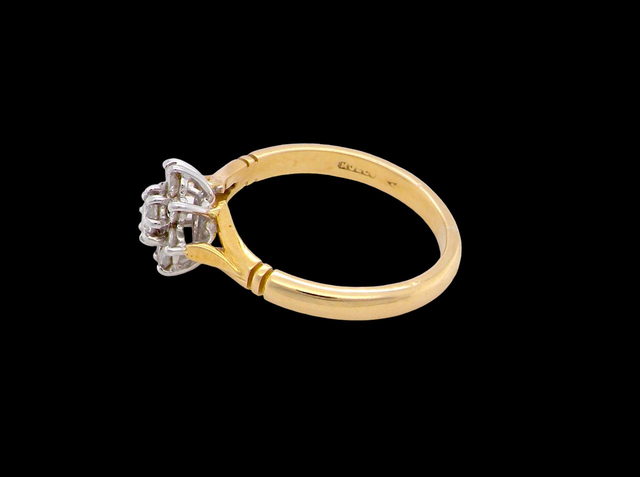 pretty cluster ring set with nine brilliant-cut white diamonds.
side