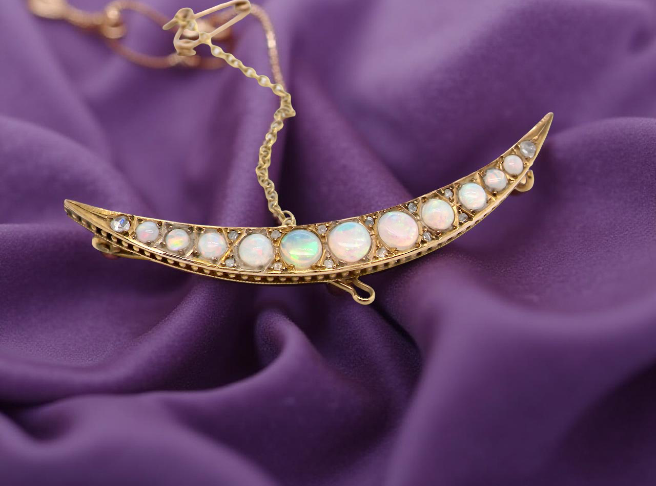 An Edwardian opal crescent shaped brooch