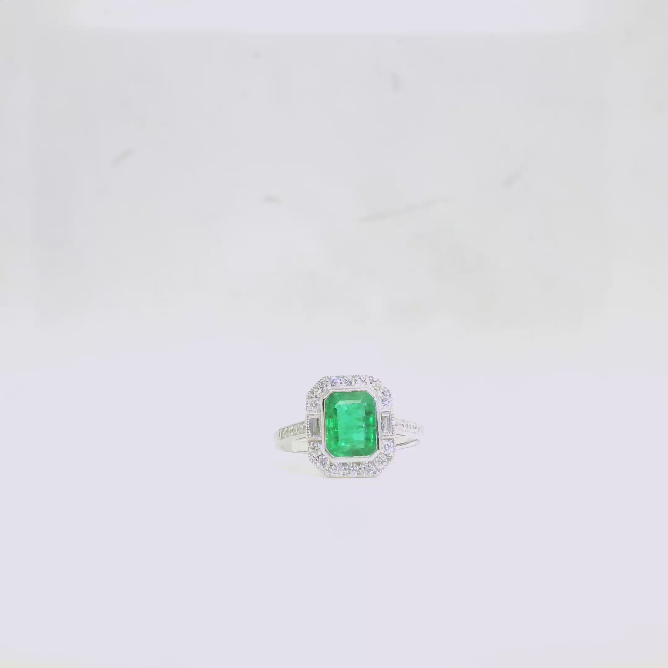 An  Emerald and Diamond Cluster Ring – 18 carat White Gold video