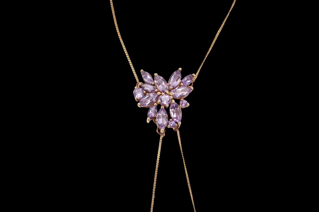 Necklace with a heart-shaped purple gemstone pendant on a black background