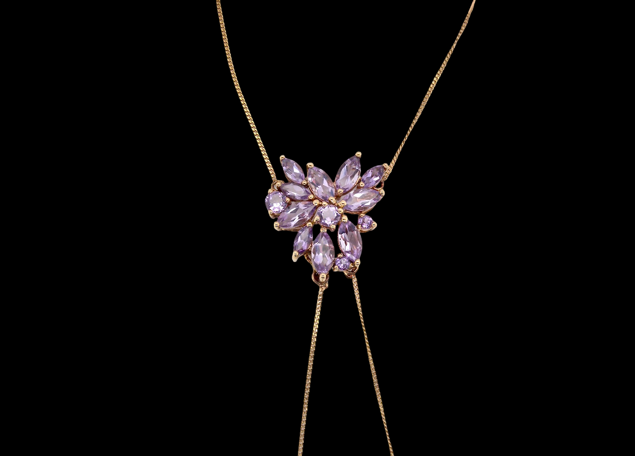 Necklace with a heart-shaped purple gemstone pendant on a black background