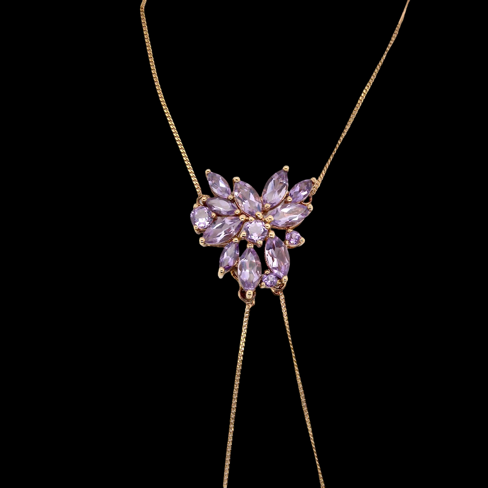 Necklace with a heart-shaped purple gemstone pendant on a black background