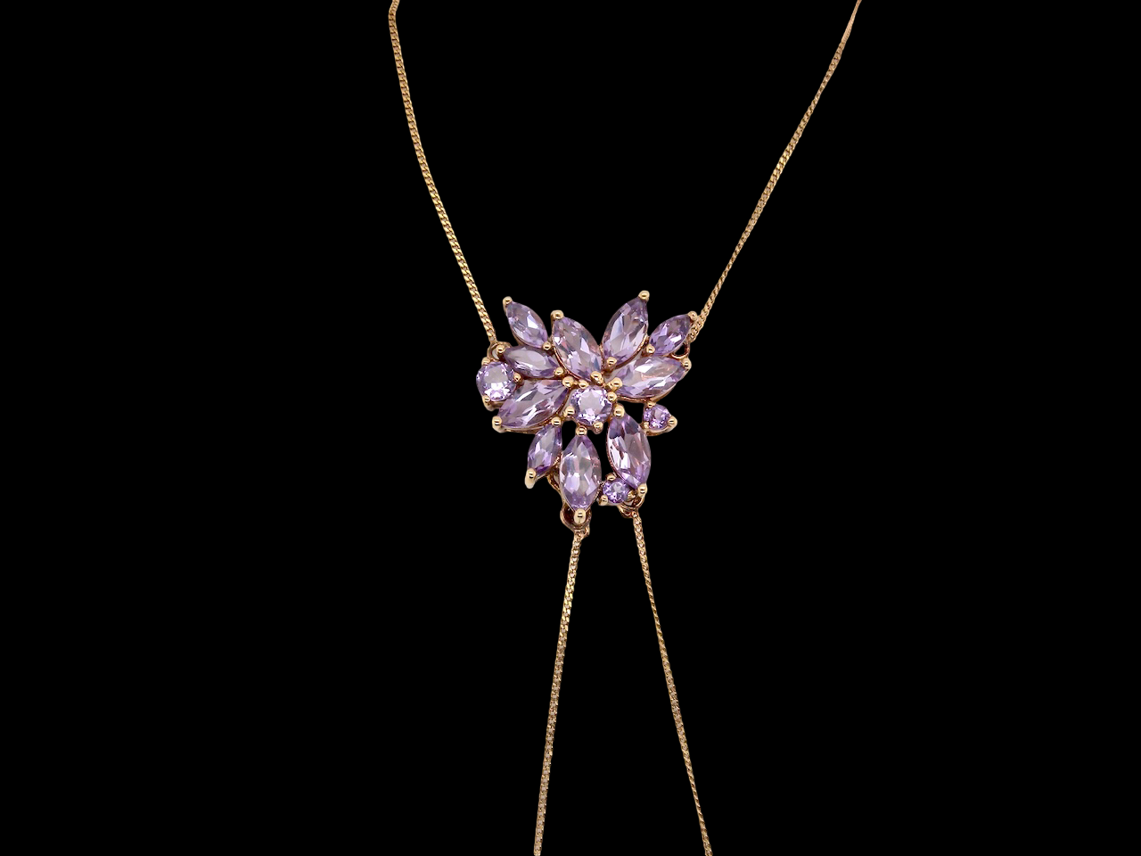 Necklace with a heart-shaped purple gemstone pendant on a black background