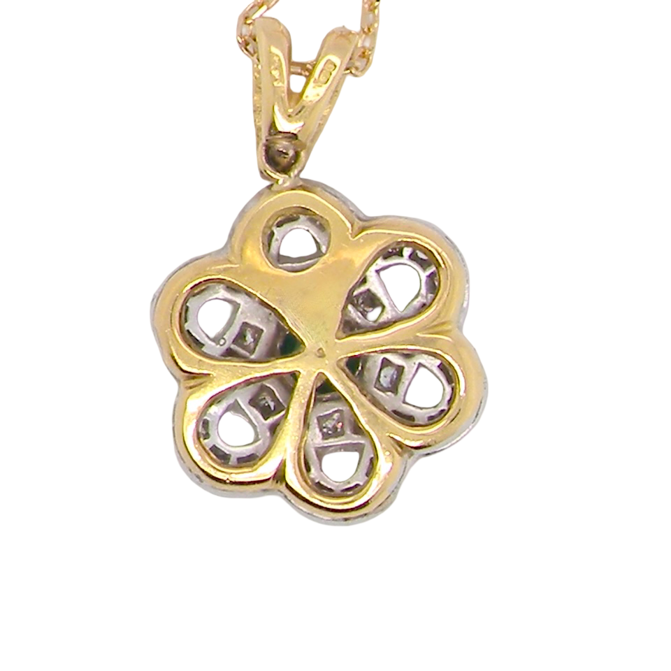 rear 8 carat gold pendant that features to the centre a round emerald