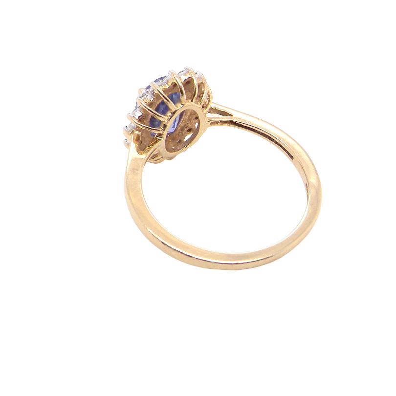 rear A 14 carat gold cluster ring. Features to the centre an oval cut cornflower blue sapphire, 8x6mm (est 1.25 carats), four claw setting.