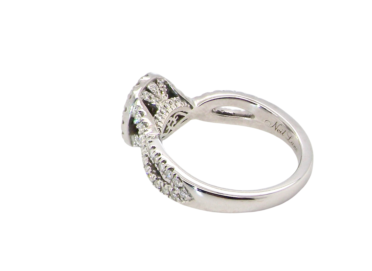 rear A 14 carat white gold cluster ring. The centre cluster an oval setting with nine small white diamonds.
Around the outside a halo of sixteen smaller diamonds,