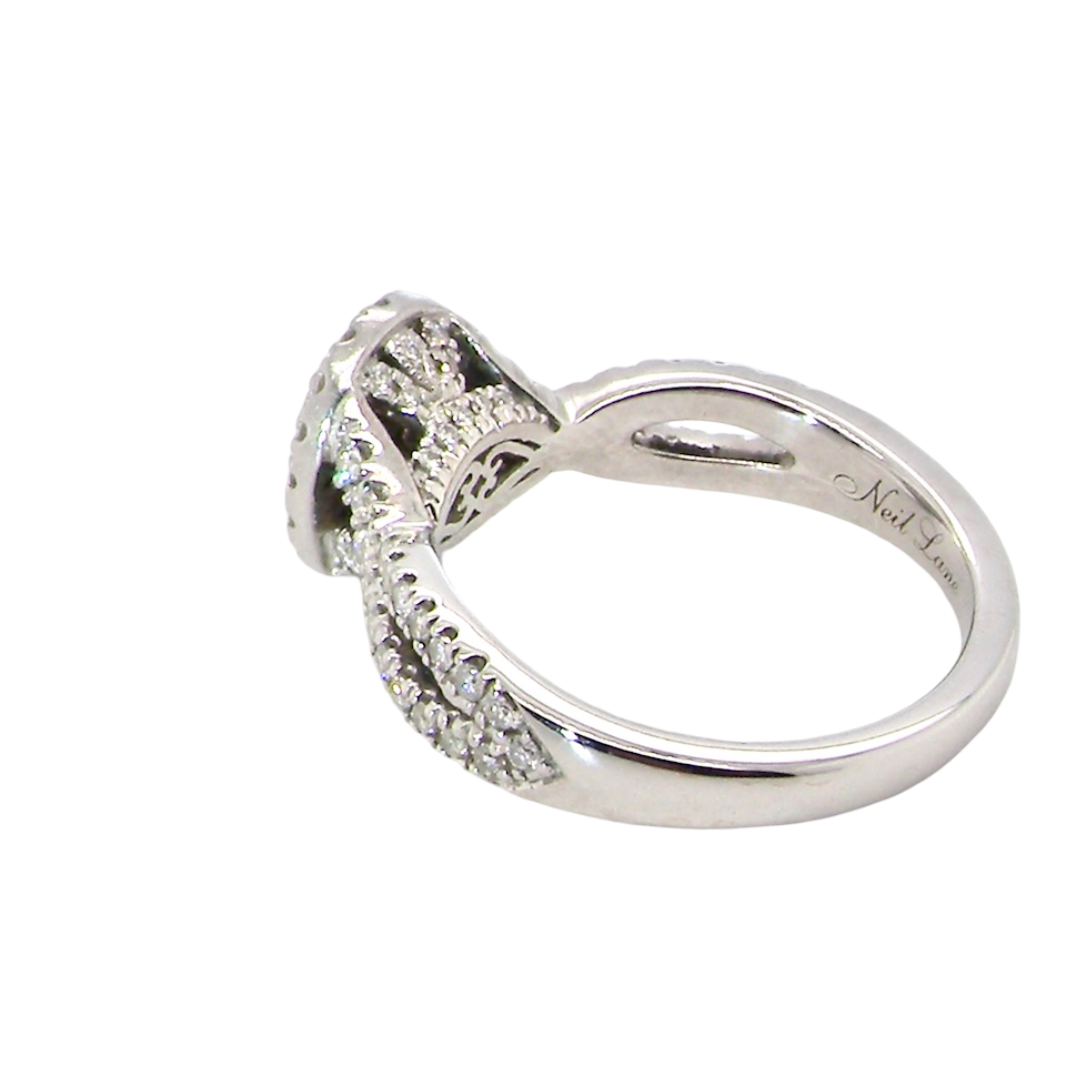rear A 14 carat white gold cluster ring. The centre cluster an oval setting with nine small white diamonds.
Around the outside a halo of sixteen smaller diamonds,