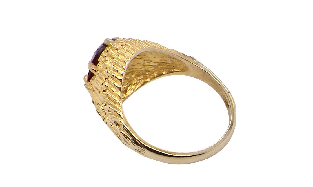 rear A 1970s dress ring set with an oval garnet stone. This measures 10x8mm and claw set.