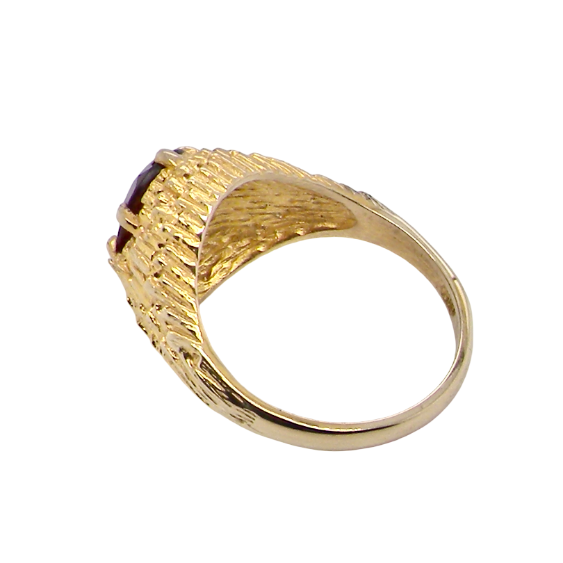 rear A 1970s dress ring set with an oval garnet stone. This measures 10x8mm and claw set.