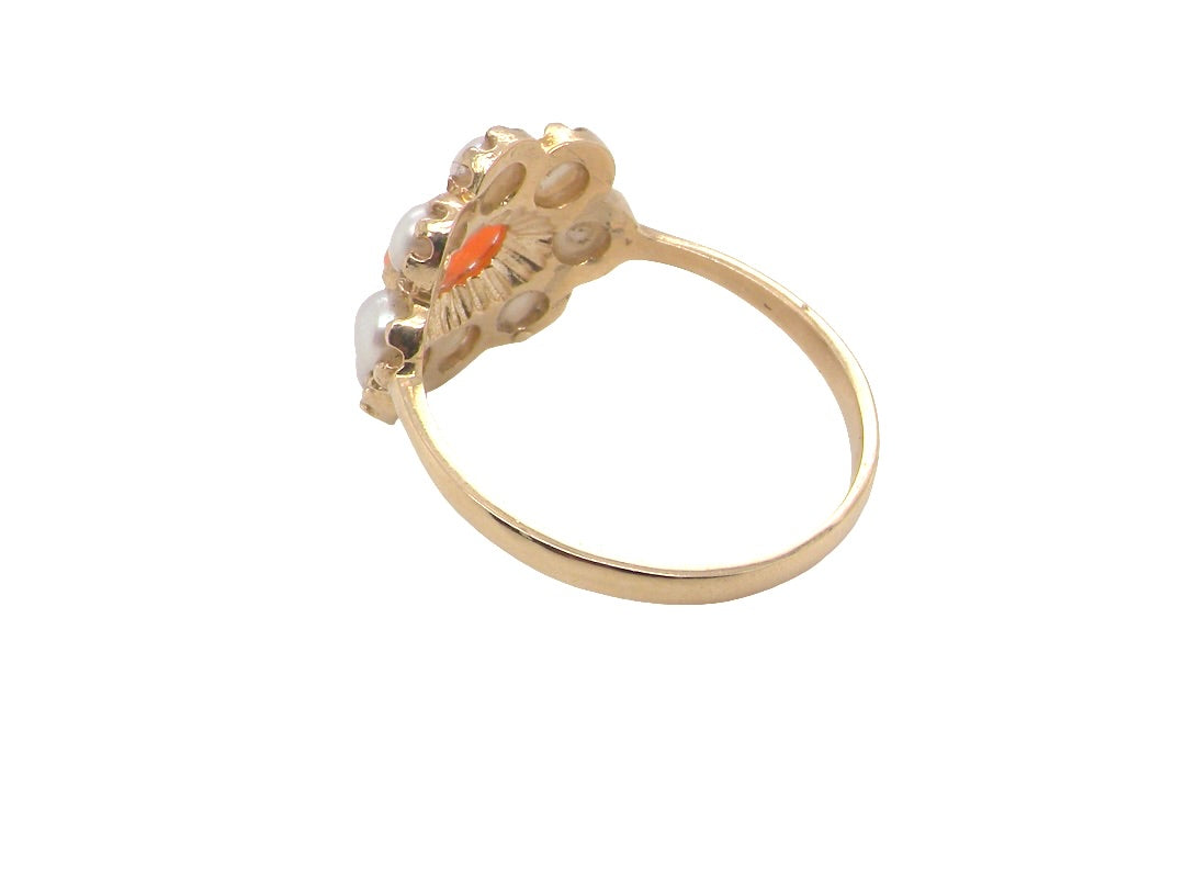 rear A 9 carat gold cluster ring. Centre stone an oval shaped coral stone 6x4mm.