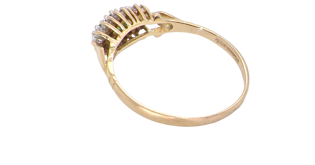 rear A 9 carat gold cluster ring. Set to the centre three round emeralds, centre 3.2mm, each side a 2.6mm stone.