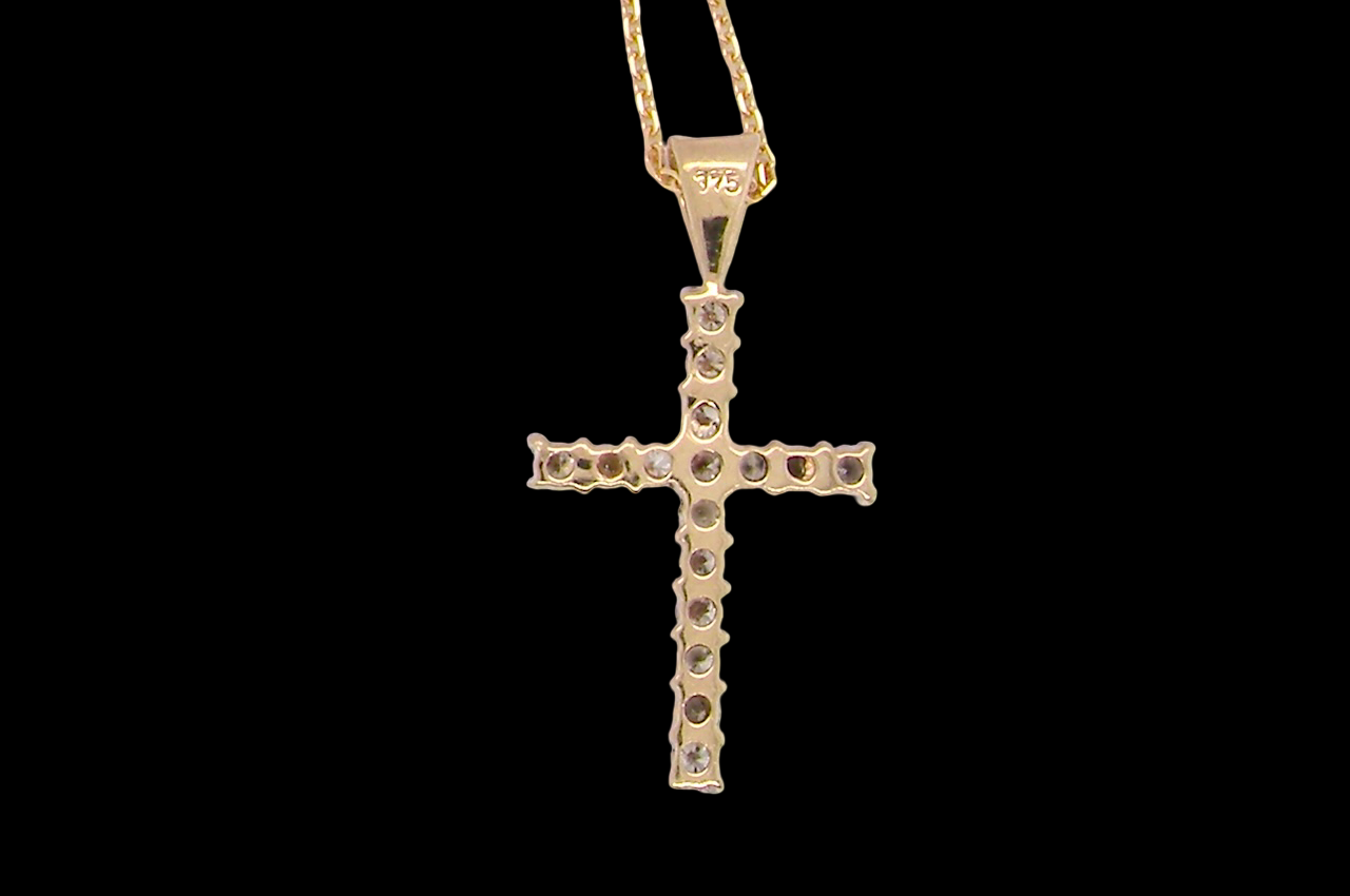 rear A 9 carat gold cross pendant. Set with fifteen small brilliant cut white diamonds.
Each 1.6mm, total carat weight estimated at 0.30 carats. Colour i-k, clarity Si. Overall size 18x12.5mm. Attached to an 18' neck chain.