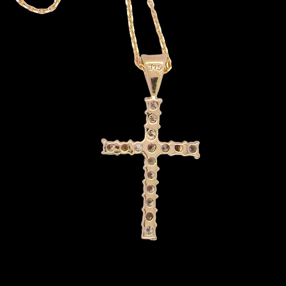 rear A 9 carat gold cross pendant. Set with fifteen small brilliant cut white diamonds.
Each 1.6mm, total carat weight estimated at 0.30 carats. Colour i-k, clarity Si. Overall size 18x12.5mm. Attached to an 18' neck chain.