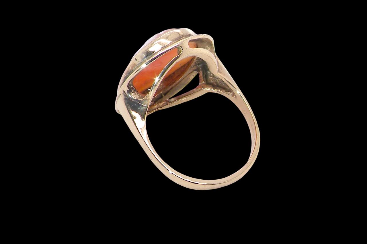 rear A 9 carat gold dress ring that features a cameo shell. Carved with the head of a young woman. Measures 20x15mm.