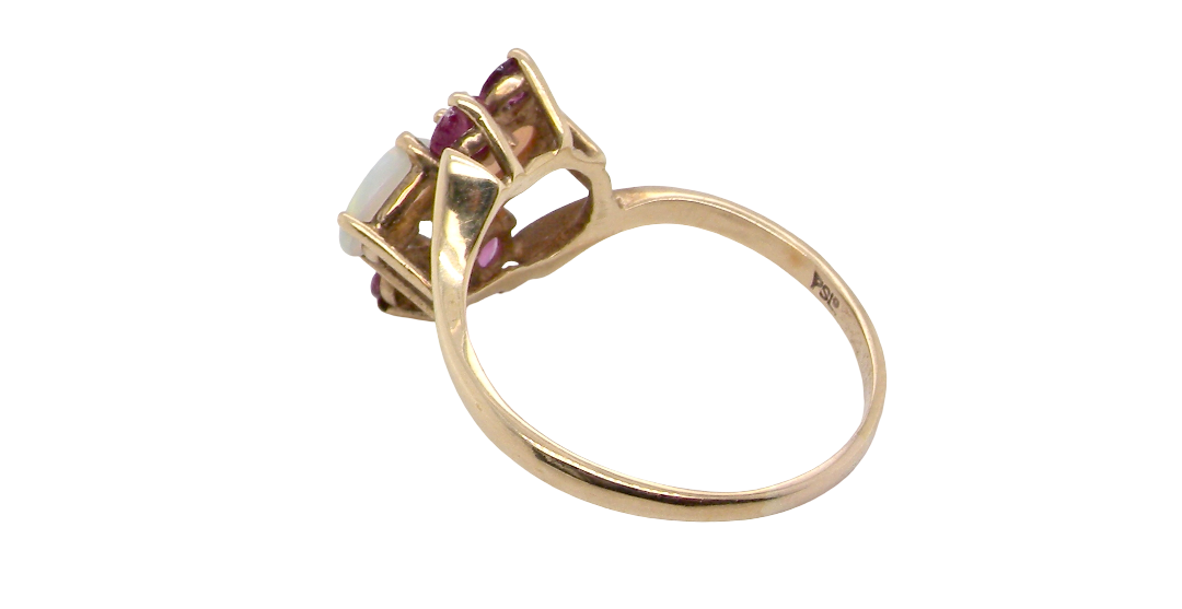 rear A 9 carat gold dress ring that features two oval white opals, each 7x5mm, and four rubies each 3.4mm.
