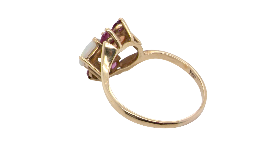 rear A 9 carat gold dress ring that features two oval white opals, each 7x5mm, and four rubies each 3.4mm.