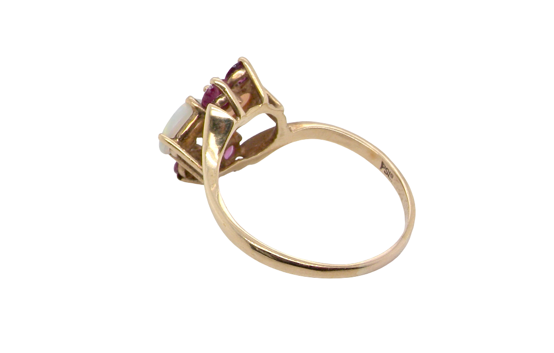 rear A 9 carat gold dress ring that features two oval white opals, each 7x5mm, and four rubies each 3.4mm.