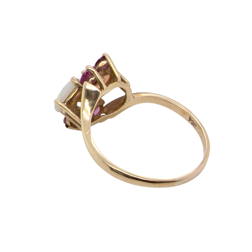 rear A 9 carat gold dress ring that features two oval white opals, each 7x5mm, and four rubies each 3.4mm.