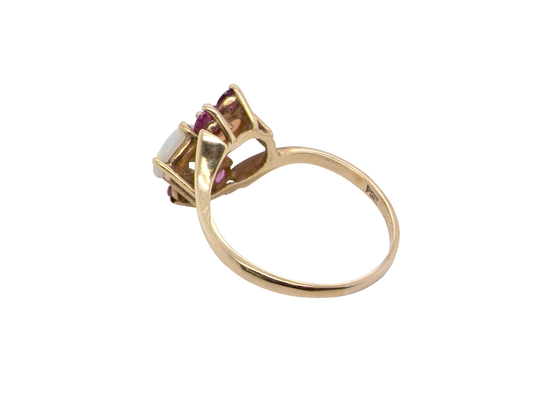 rear A 9 carat gold dress ring that features two oval white opals, each 7x5mm, and four rubies each 3.4mm.