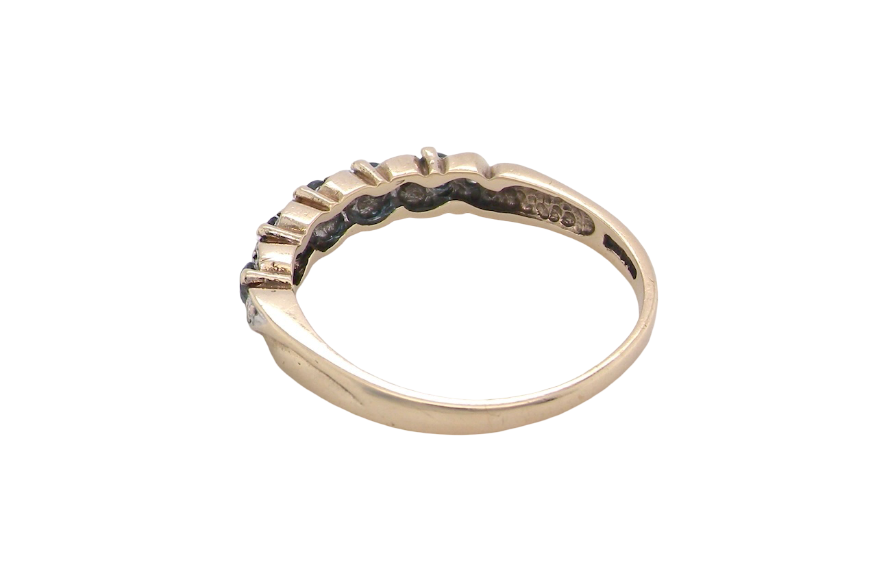 rear A 9 carat gold half hoop eternity ring. Set with five blue topaz gem stones, each 2.8mm. 