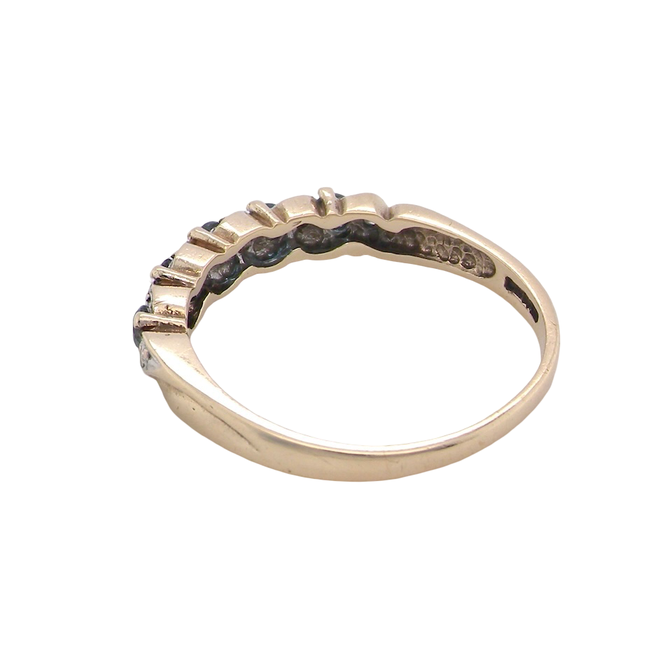 rear A 9 carat gold half hoop eternity ring. Set with five blue topaz gem stones, each 2.8mm. 