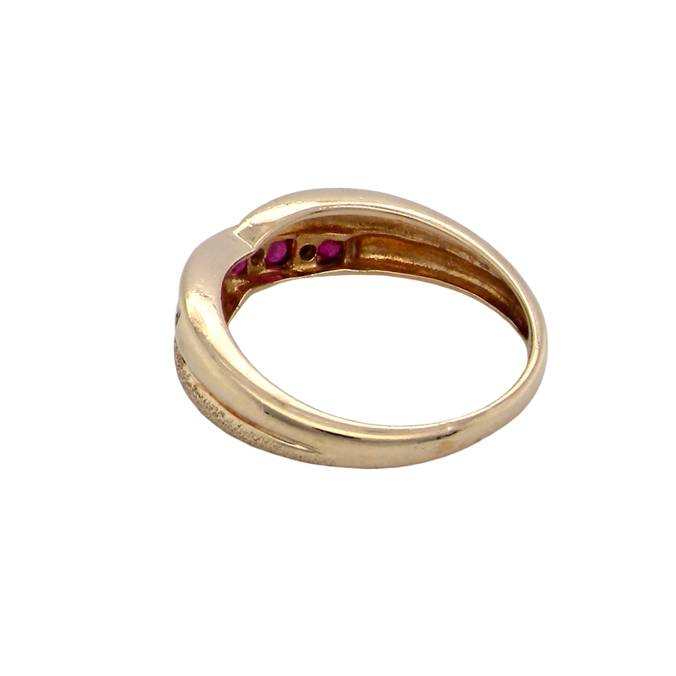 rear A 9 carat gold half hoop eternity ring. Set with five calibre cut rubies, from 1.7 to 2mm, and between small 1mm white diamonds.