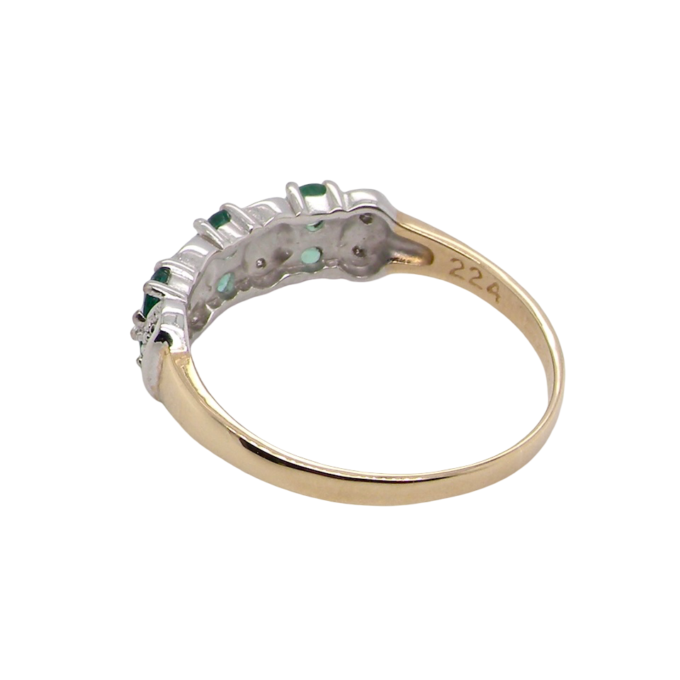 rear A 9 carat gold half hoop ring. Set with six round emeralds 3mm each,(total 0.35 carats est) and interspaced with vertical white gold sections each set with 1mm diamonds.(0.05 carats est)