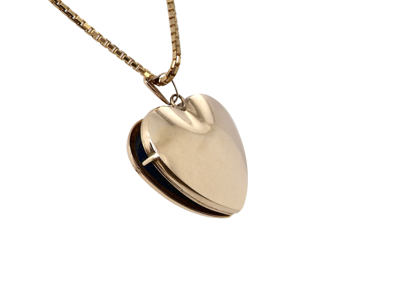A 9 carat gold heart shaped locket. 25x25mm, part hand engraved front, plain reverse