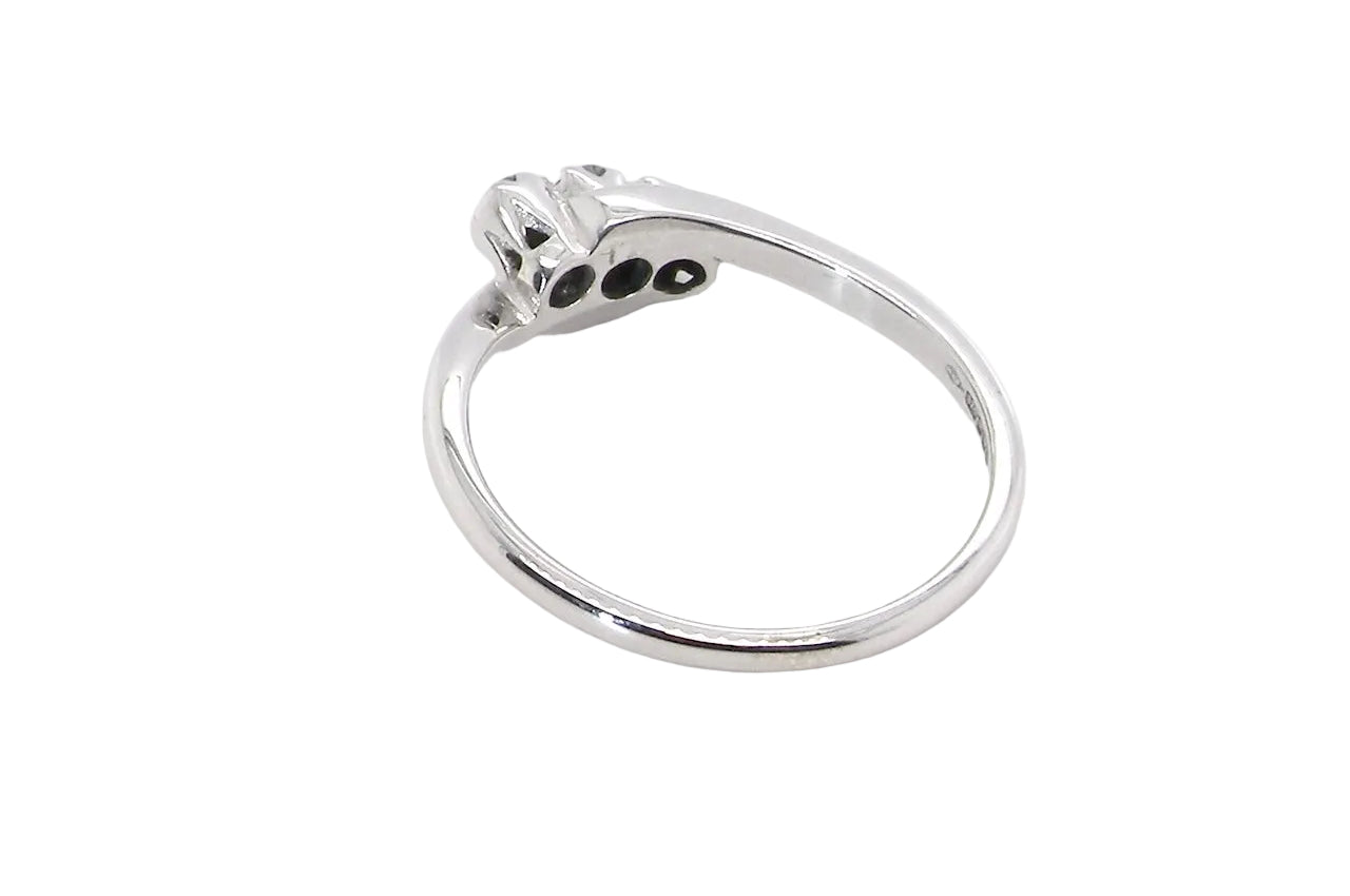 rear A 9 carat white gold cross over style trilogy ring. Three x 0.10mm diamonds, to an estimated at 0.30 carats.